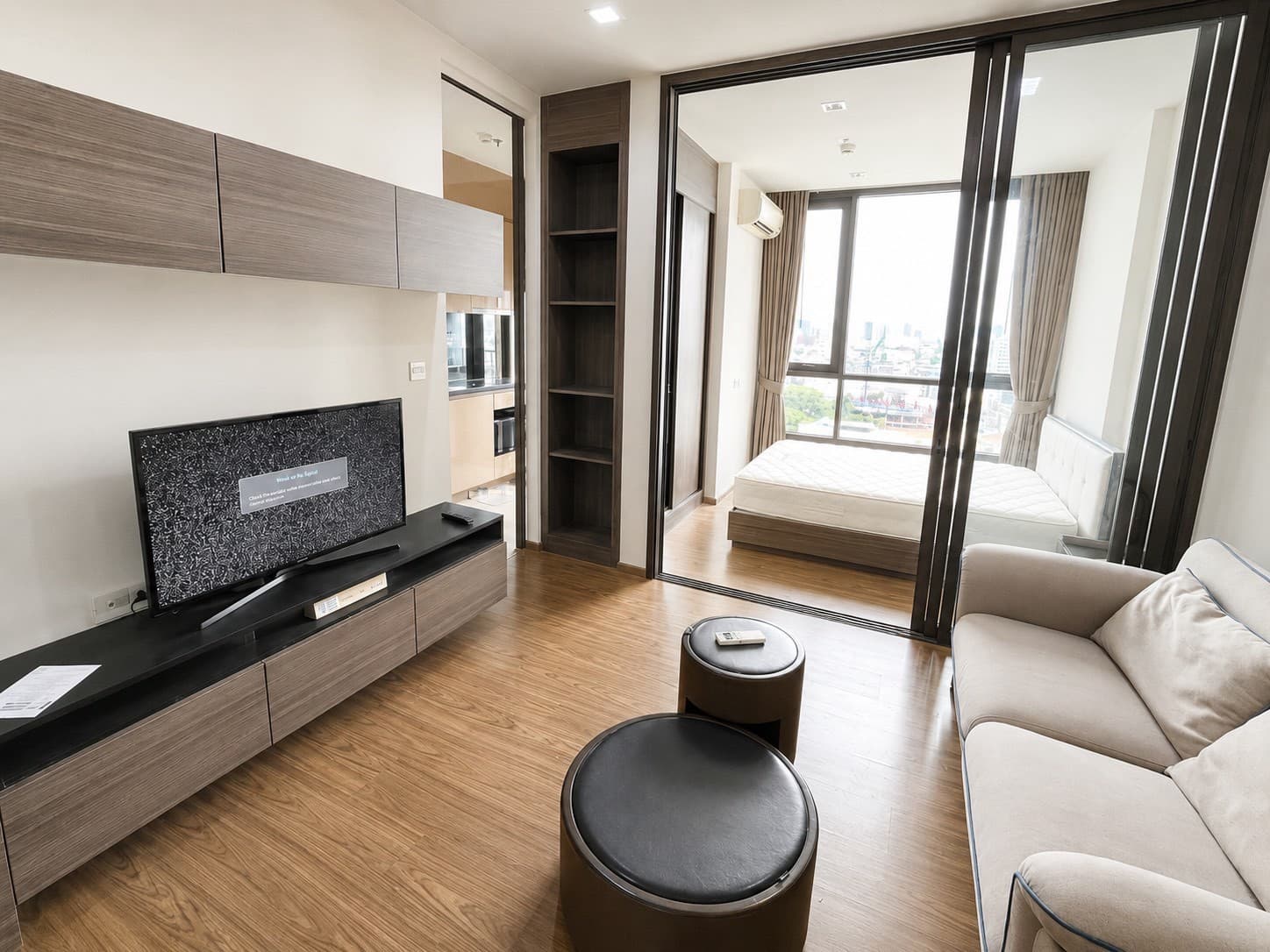Glass-walled bedroom, open outlook — The Line Sukhumvit 71