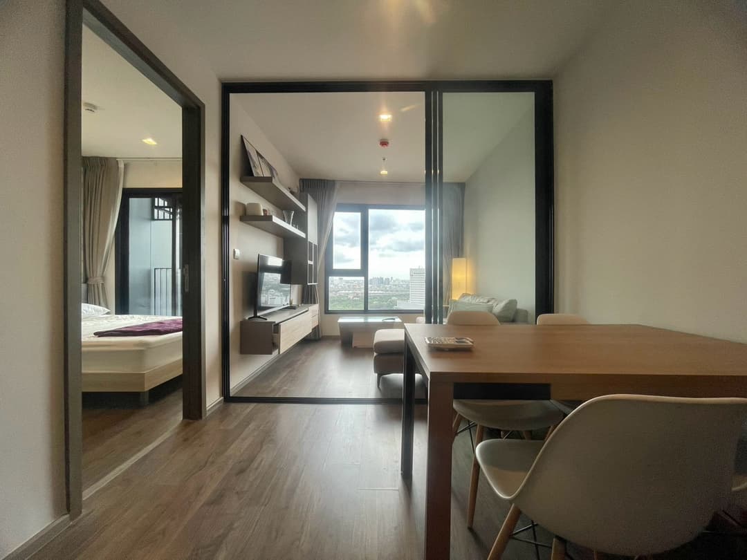 Glass-partition bedroom, warm wood — Life Ladprao Valley photo 1
