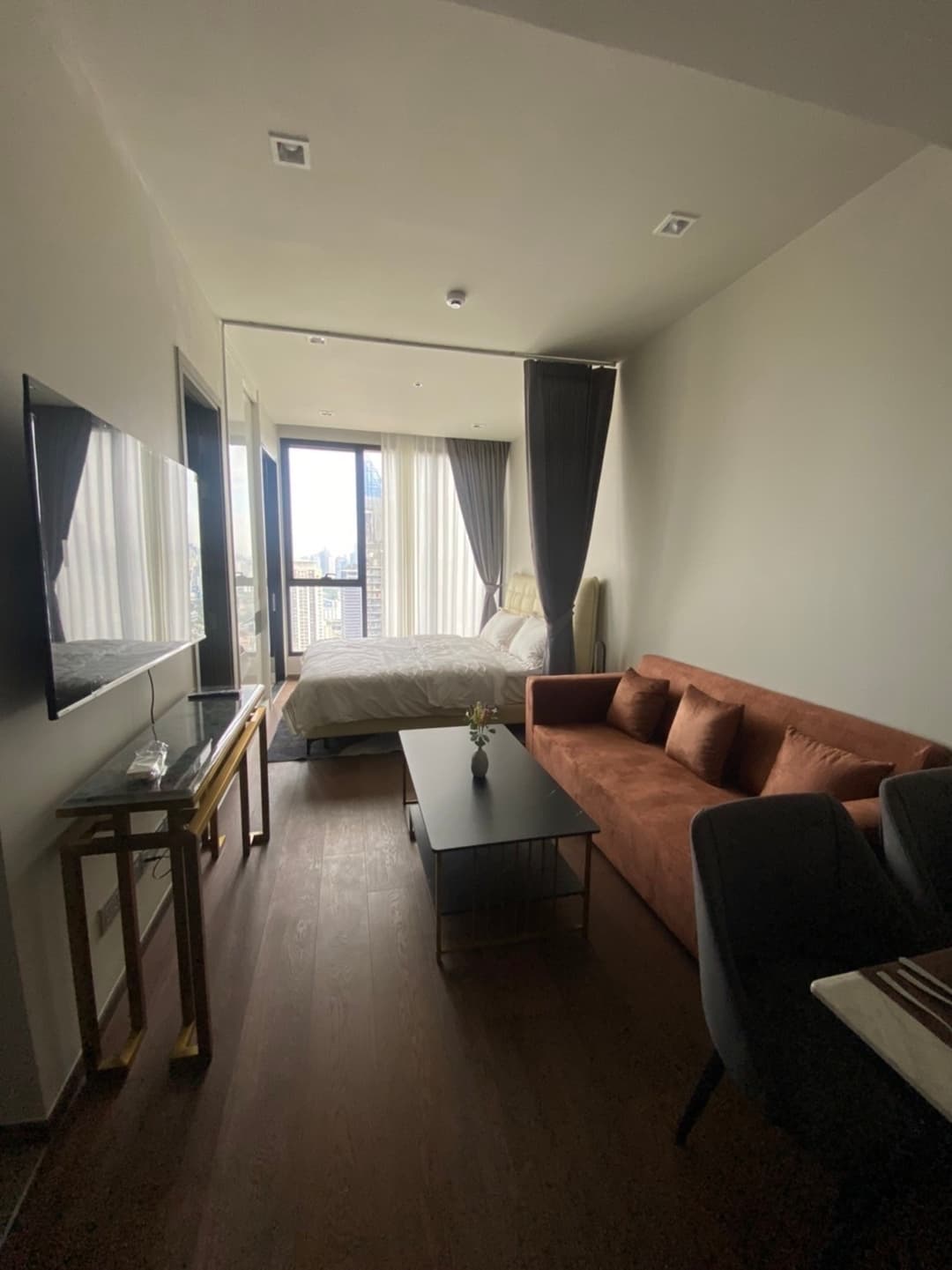 Warm wood-toned 1BR with city-view balcony — IDEO Q Victory photo 1